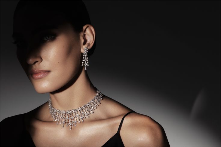 Woman wearing an ornate diamond necklace and earrings